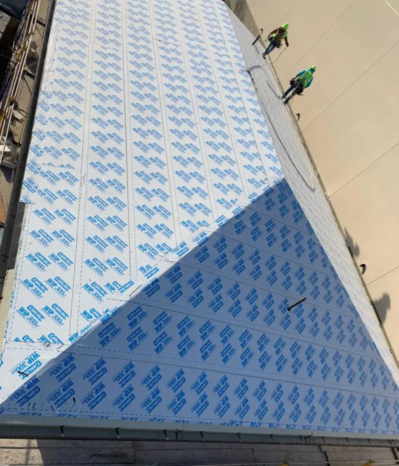 Professional roofers installing underlayment on a metal roof in Sidney